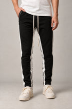 Side Stripe Track Pants 'Hashiri' – black version of the side stripe track pants with white stripe, front view on model