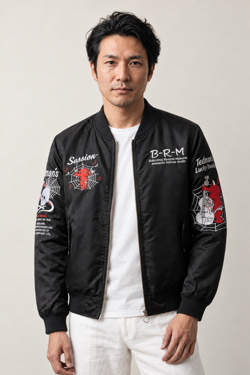 Skull and Serpent Bomber Jacket 'Dokuja' – black bomber jacket with embroidered skull, serpent and lettering patches, Japanese streetwear, front view on model