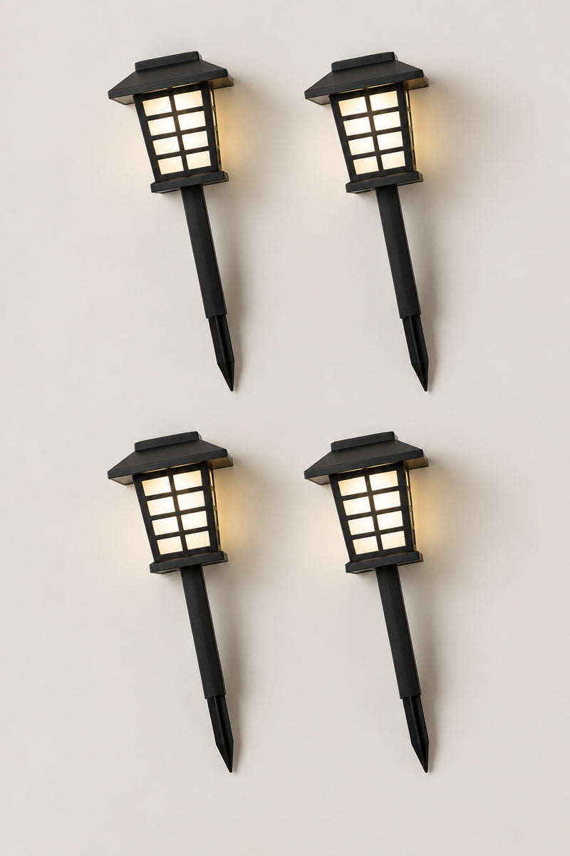Solar Japanese Garden Lanterns 'Michiakari' – set of four solar Japanese garden path lanterns on stakes, lit, studio view