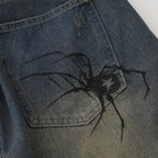 Spider Web Print Denim Shorts 'Kumonosu' – close-up detail of the printed spider on the pocket