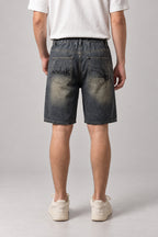 Spider Web Print Denim Shorts 'Kumonosu' – back view of the dark washed denim shorts, on model