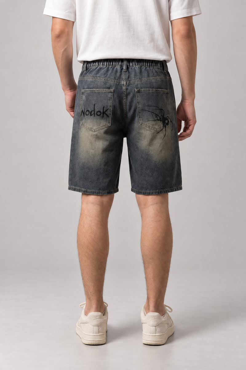 Spider Web Print Denim Shorts 'Kumonosu' – back view of the dark washed denim shorts, on model