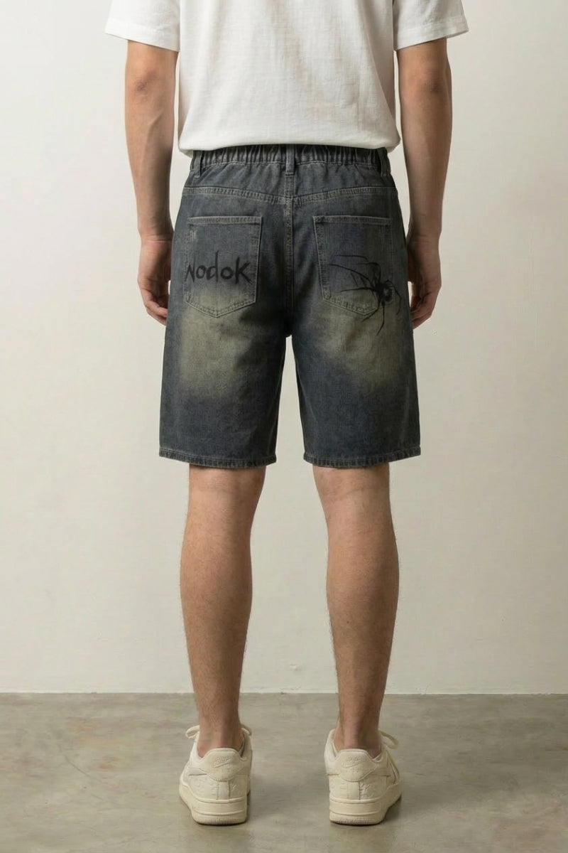 Spider Web Print Denim Shorts 'Kumonosu' – back view on model, studio
