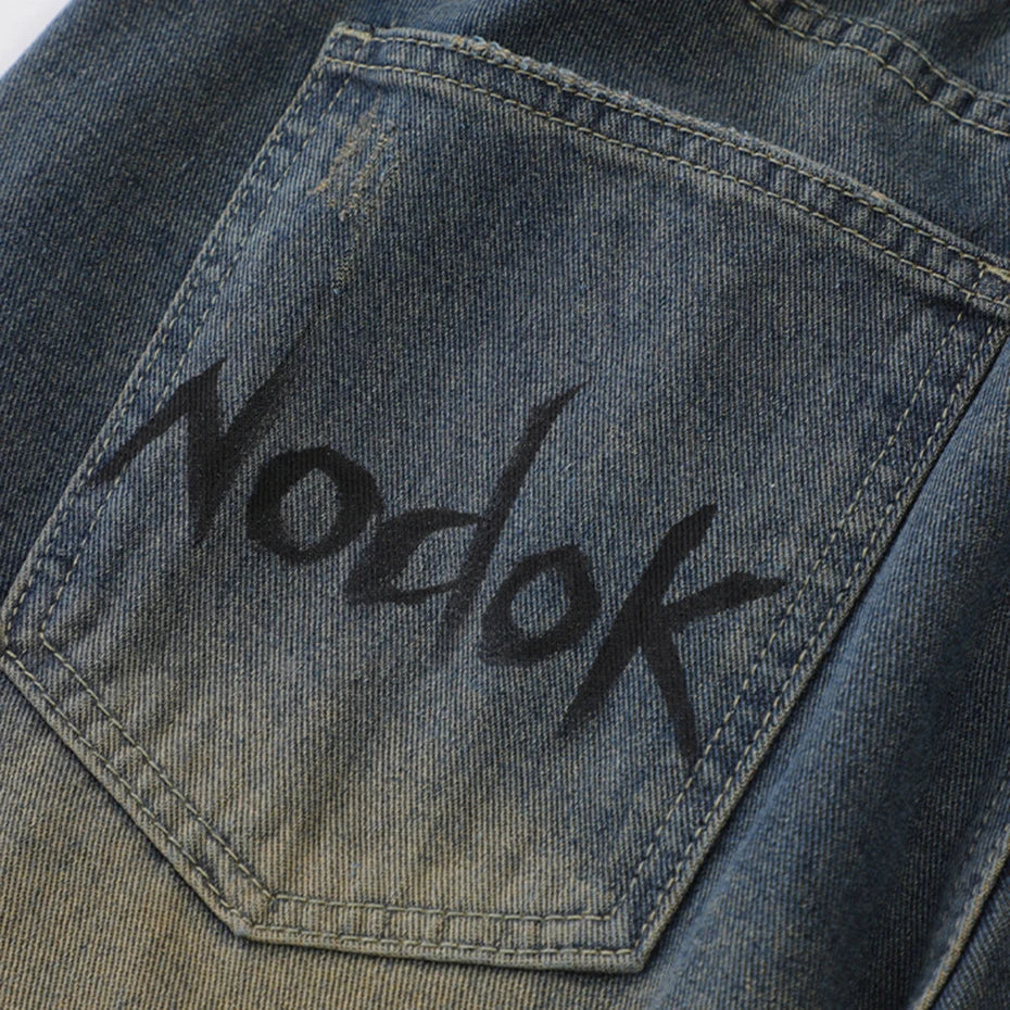 Spider Web Print Denim Shorts 'Kumonosu' – close-up detail of the printed lettering on the rear pocket