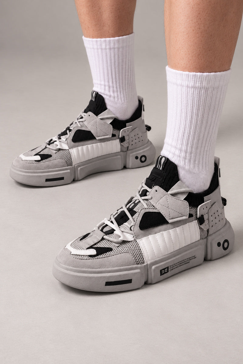 Strapped Utility Chunky Sneakers 'Yoroi' – grey and black version of the strapped chunky sneakers, Japanese streetwear sneakers worn with white socks, on model