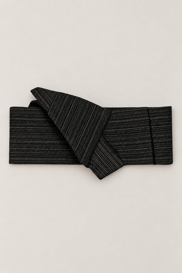 Striated Black Obi Style Belt 'Hosome' – black obi belt striated in fine grey lines, narrow pre-tied Japanese obi belt with sewn knot and hidden adjustable closure, for kimono, yukata or jinbei, studio view