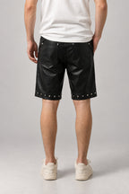 Studded Faux Leather Shorts 'Byo' – back view of the black studded faux leather shorts, on model