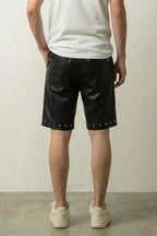 Studded Faux Leather Shorts 'Byo' – back view on model, studio