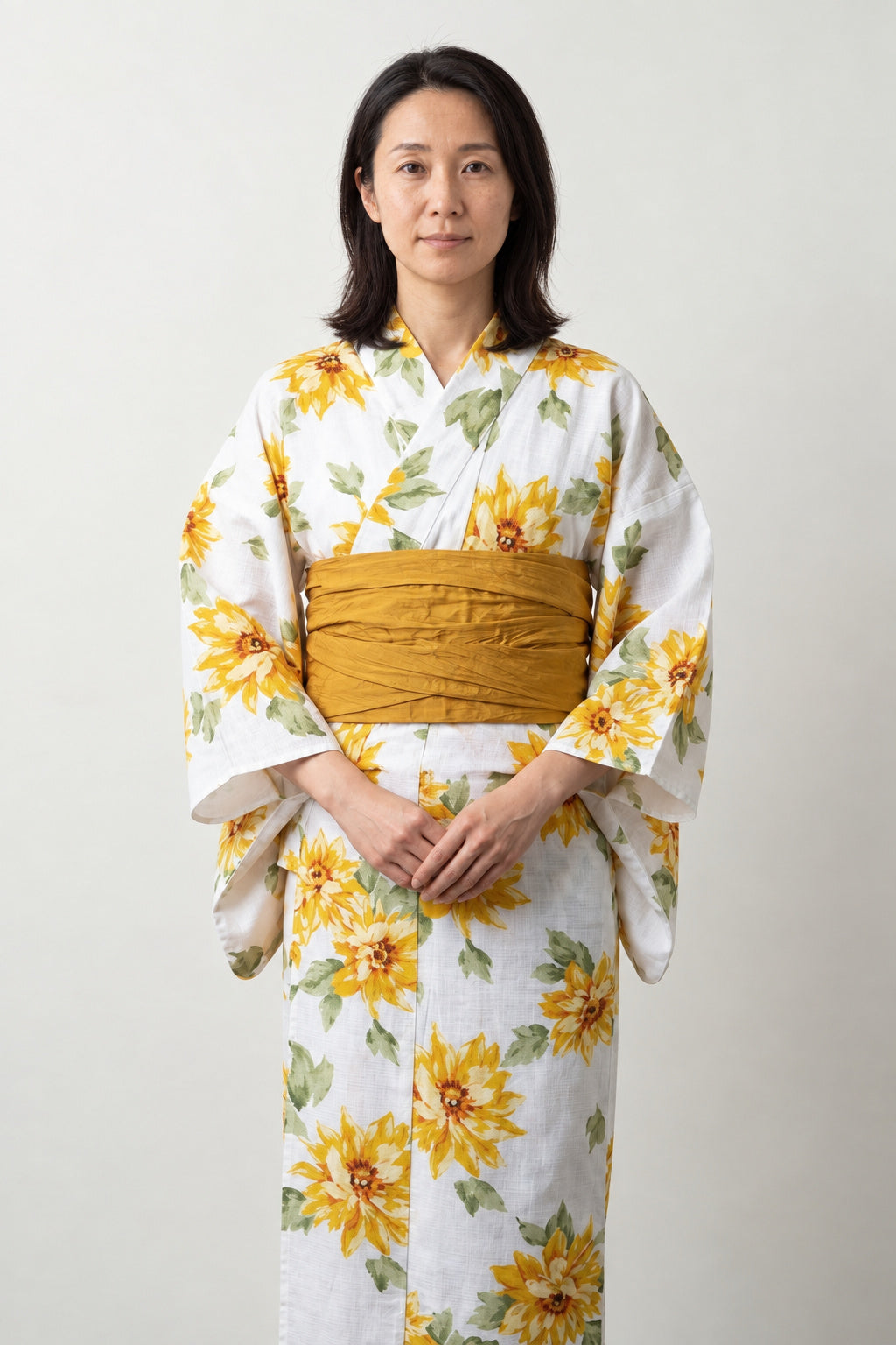 Sunflower Summer Yukata 'Natsubi' – white women's summer yukata with yellow sunflower print and mustard obi belt, traditional Japanese kimono, front view on model