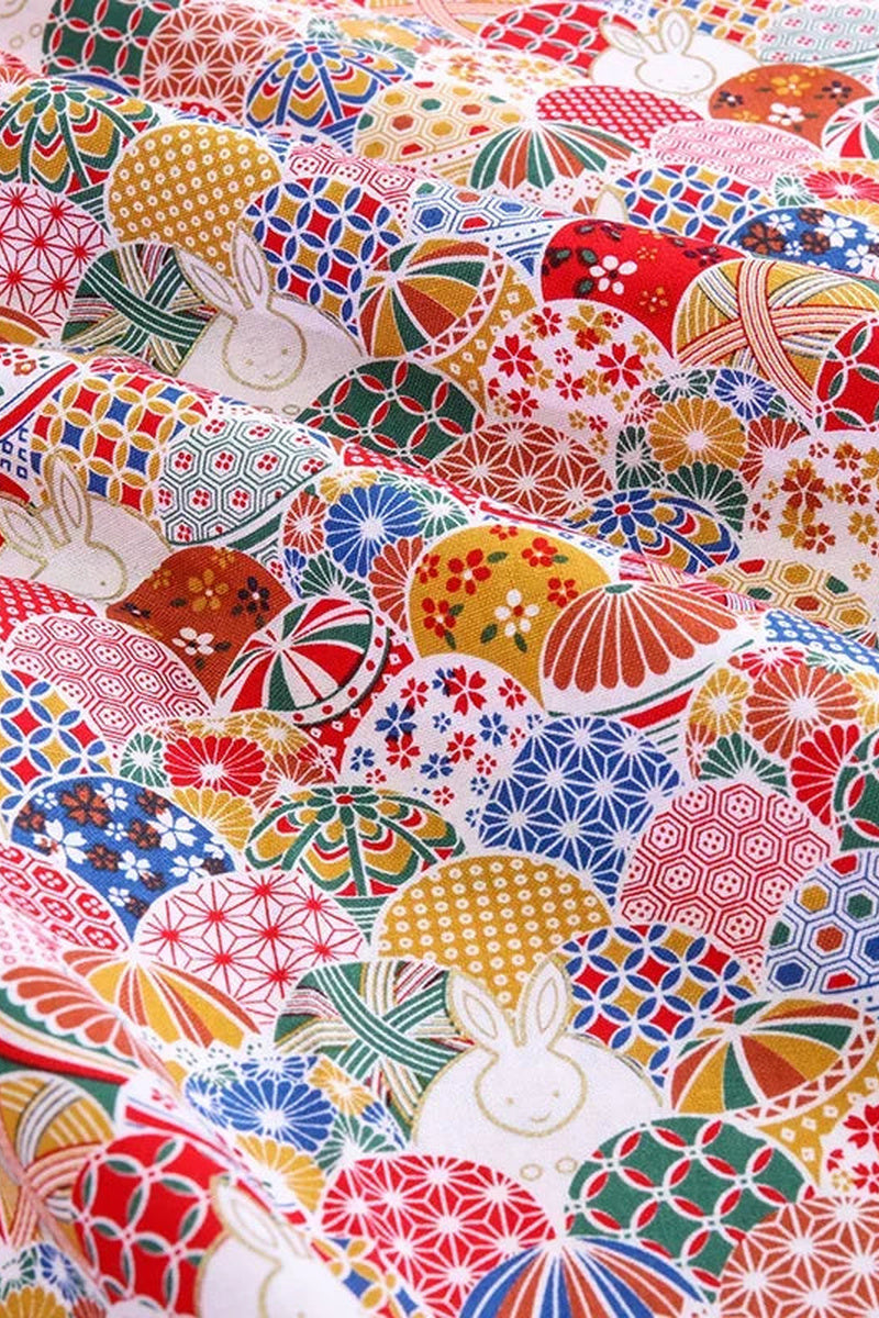 Temari Rabbit Furoshiki 'Usagimari' – red furoshiki printed with patterned temari thread balls and white rabbits, Japanese furoshiki wrapping cloth 50 by 145 cm, close-up of the print