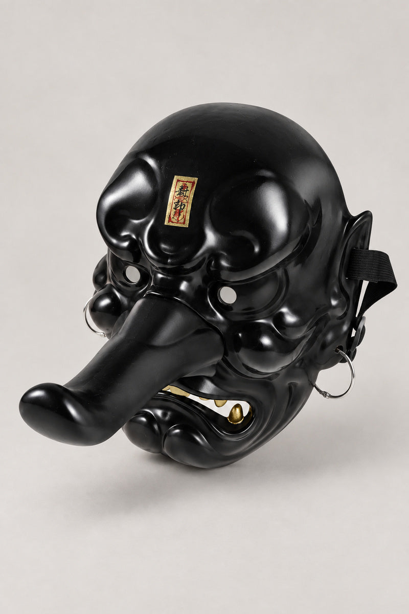 Tengu Mask 'Karasu' – all black version of the tengu mask with long nose and gold swirls, studio view