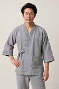 Tortoiseshell Trim Japanese Pyjamas 'Kikko' – grey jinbei pyjamas with tortoiseshell pattern trim and pocket, unisex two-piece Japanese jinbei set with side-tie top and shorts, front view on model