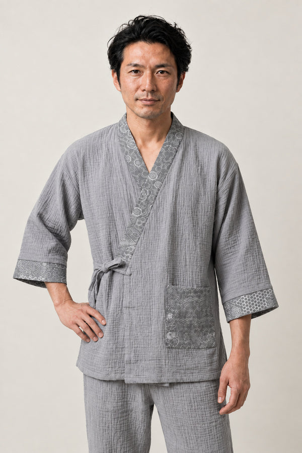 Tortoiseshell Trim Japanese Pyjamas 'Kikko' – grey jinbei pyjamas with tortoiseshell pattern trim and pocket, unisex two-piece Japanese jinbei set with side-tie top and shorts, front view on model
