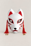 Traditional Fox Mask 'Shiragitsune' – white kitsune fox mask with red ears, red eye sweeps, red tassels and brass bells, classic, Japanese kitsune festival mask, studio view