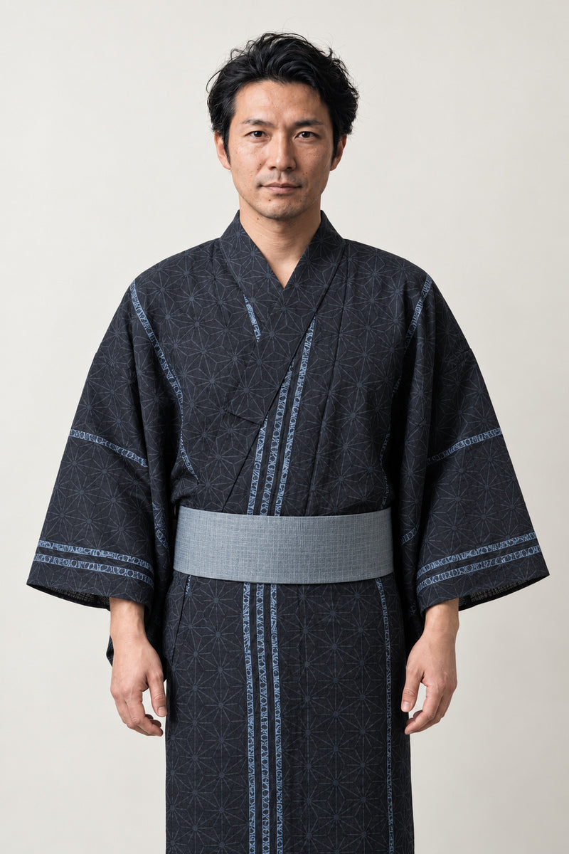 Traditional Men's Yukata 'Asanoha' – black men's yukata with fine striped pattern and grey obi belt, traditional Japanese kimono robe, front view on model