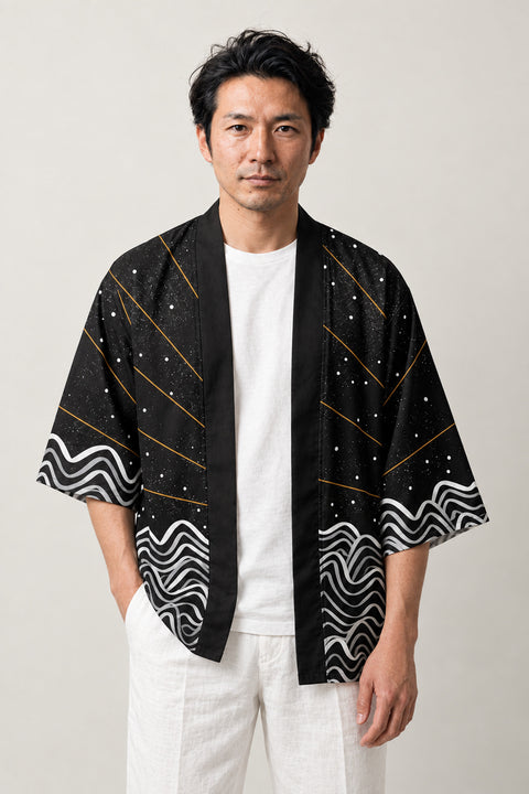 Traditional Sunburst Haori 'Nissho' – black haori jacket with gold sunburst rays and white wave print on the hem, unisex Japanese kimono style cardigan, front view on model
