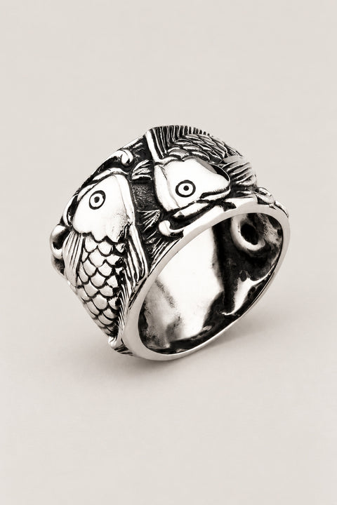 Twin Koi Ring 'Futagoi' – wide stainless steel ring with two koi carp curling round each other in high relief, Japanese koi fish ring, studio view
