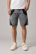 Two Tone Panelled Denim Shorts 'Hagi' – grey two tone panelled denim shorts with black inserts and studs, Japanese streetwear shorts, front view on model
