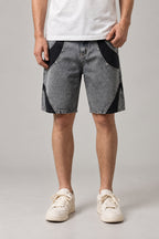 Two Tone Panelled Denim Shorts 'Hagi' – grey two tone panelled denim shorts with black inserts and studs, Japanese streetwear shorts, front view on model