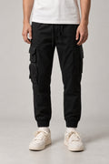 Utility Pocket Cargo Joggers 'Tetsu' – black utility cargo joggers with multiple pockets and cuffed hem, Japanese streetwear trousers, front view on model