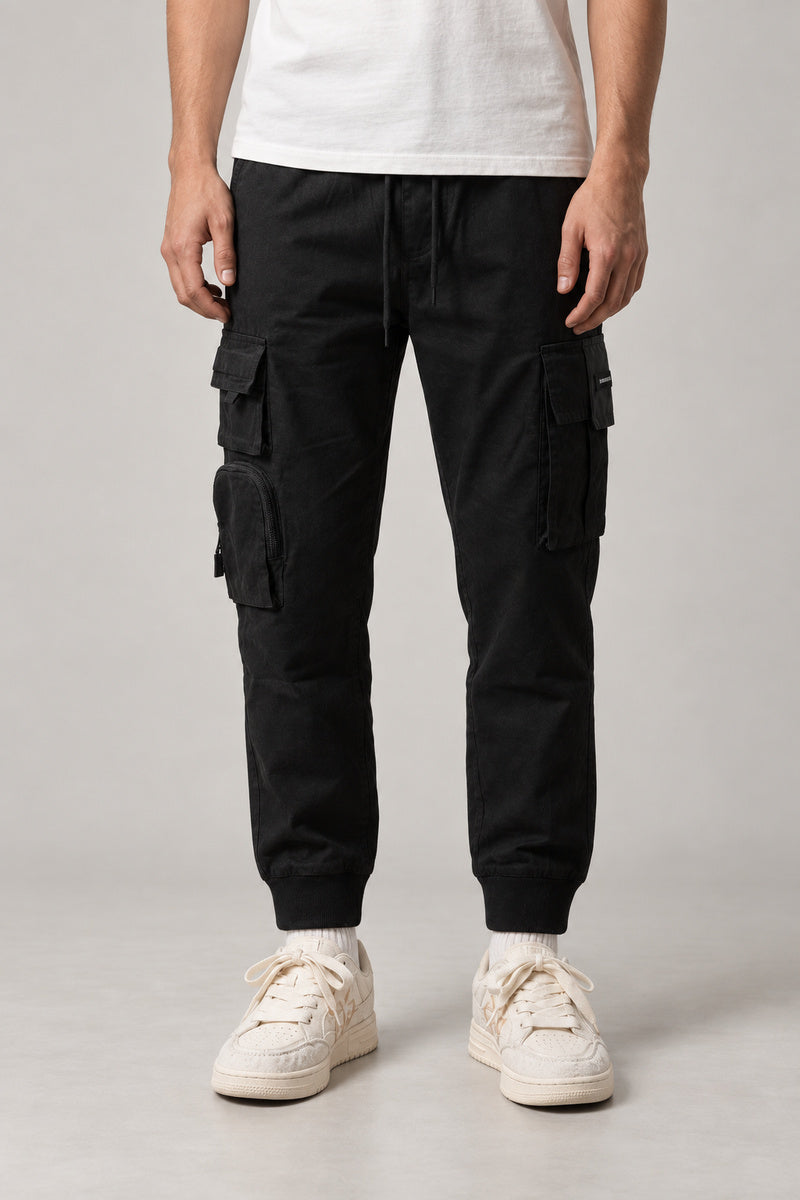 Utility Pocket Cargo Joggers 'Tetsu' – black utility cargo joggers with multiple pockets and cuffed hem, Japanese streetwear trousers, front view on model
