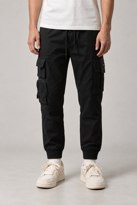 Utility Pocket Cargo Joggers 'Tetsu' – black utility cargo joggers with multiple pockets and cuffed hem, Japanese streetwear trousers, front view on model