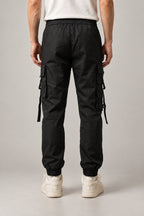Utility Pocket Cargo Joggers 'Tetsu' – black cargo joggers with hanging straps and buckles, front view on model