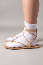 Waraji Sandals – waraji sandals with rope ties worn over white tabi socks, side view on model