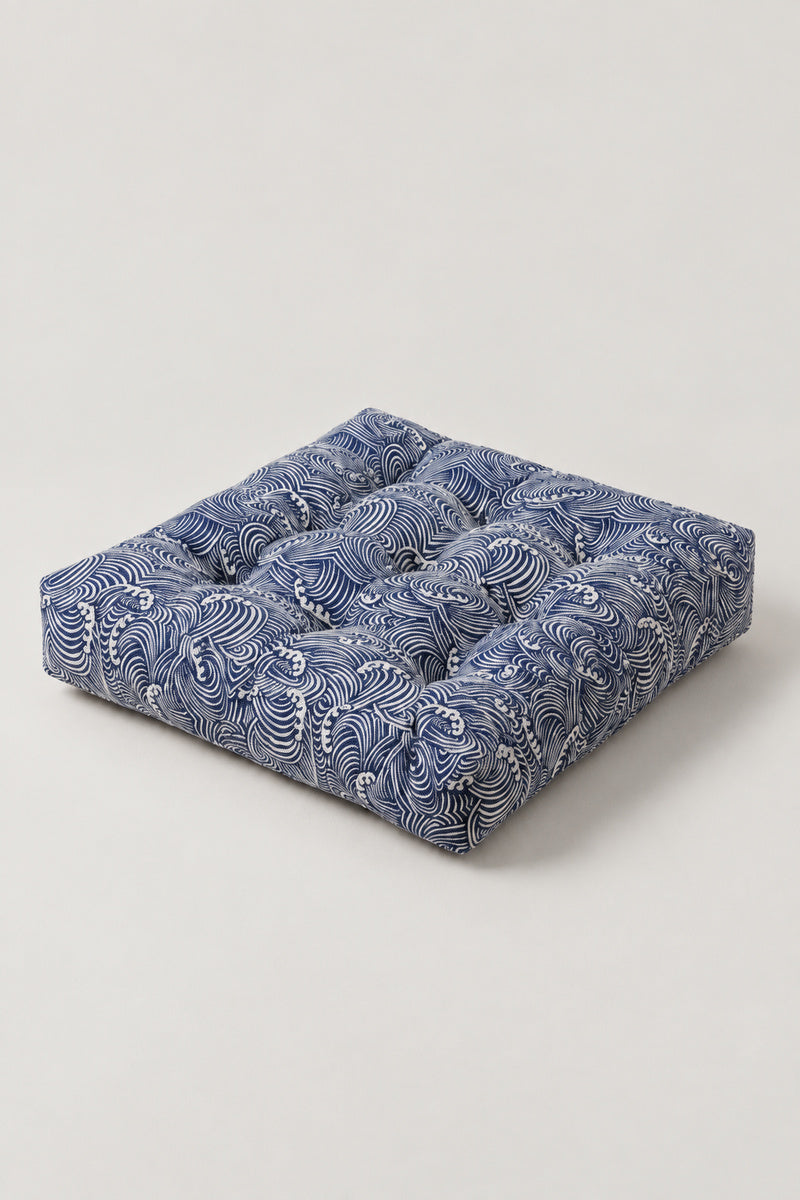Wave Patchwork Chair Cushion 'Namiza' – square tufted chair cushion in a diagonal patchwork of blue Japanese wave prints, Japanese seat pad, studio view
