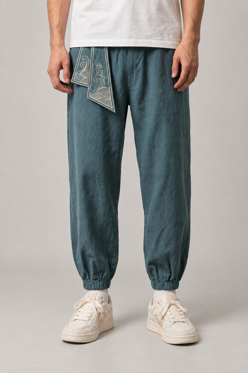 Wave Sash Harem Pants 'Namiobi' – teal harem pants with wave print sash at the waist, Japanese streetwear trousers, front view on model