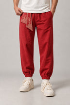 Wave Sash Harem Pants 'Namiobi' – red version of the wave sash harem pants, front view on model