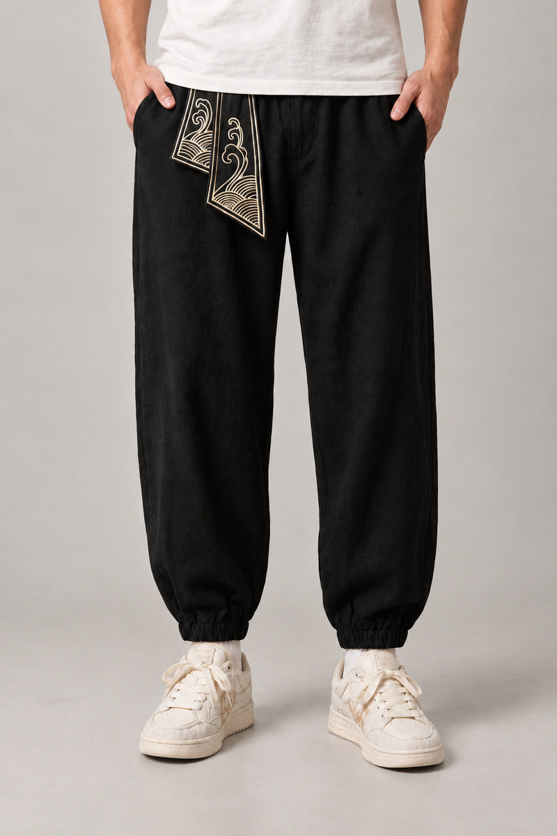 Wave Sash Harem Pants 'Namiobi' – black version of the wave sash harem pants, front view on model