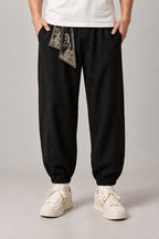 Wave Sash Harem Pants 'Namiobi' – black version of the wave sash harem pants, front view on model