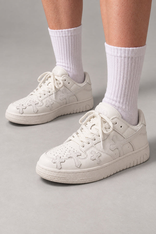White Cross Patch Sneakers 'Jujika' – all white skate sneakers with tonal cross patches, Japanese streetwear sneakers worn with white socks, on model