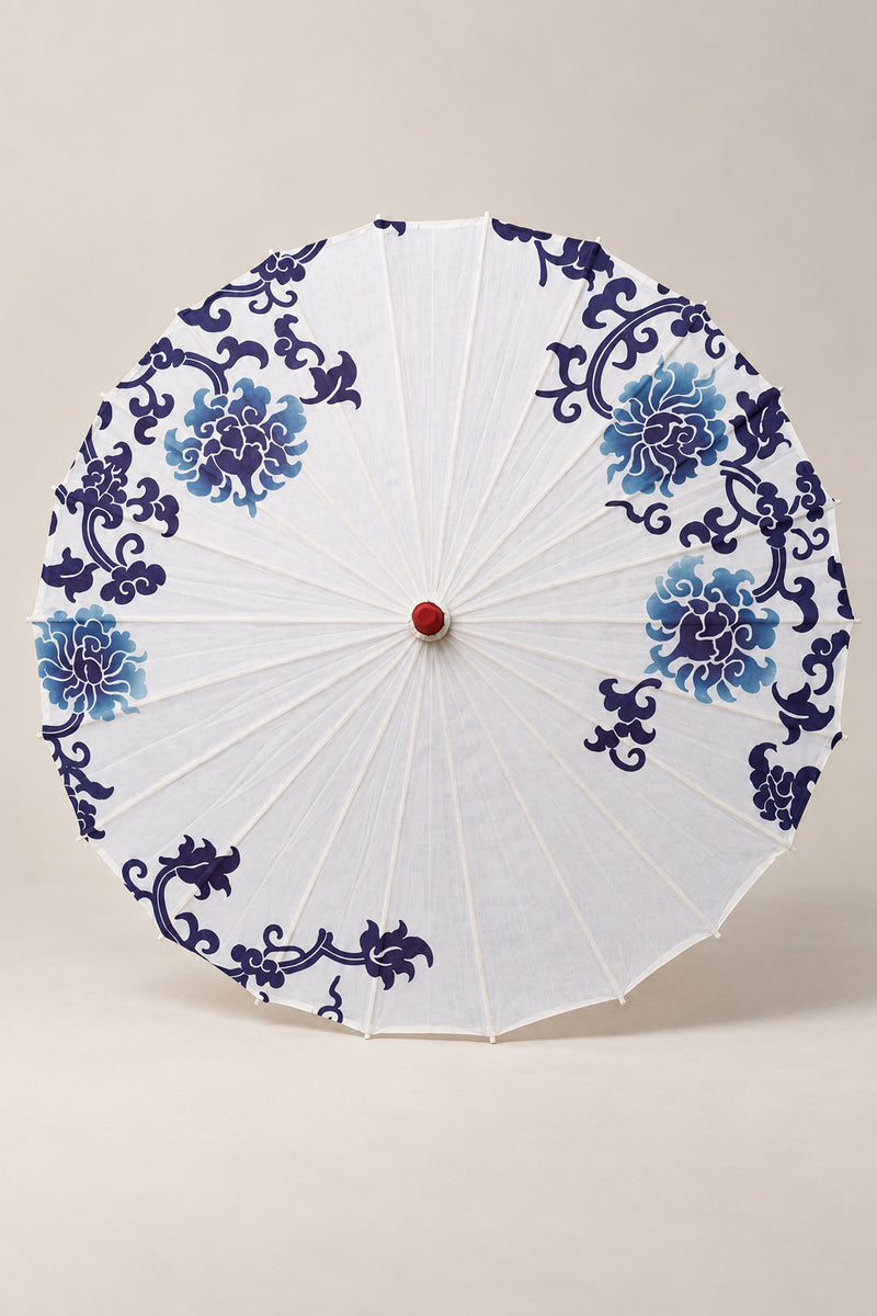 White Japanese Parasol 'Aohana' – white parasol printed with blue peonies and scrolls in blue-and-white porcelain style, Japanese wagasa parasol with wooden frame and paper-effect canopy, open, studio view