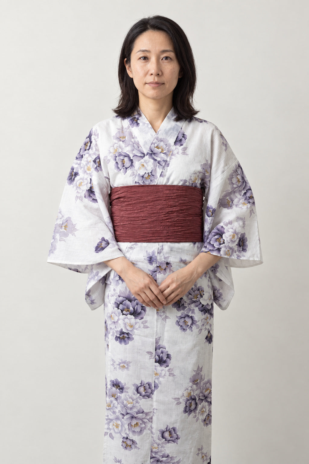 White Peony Kimono 'Shion' – white women's kimono with purple peony print and dark red obi belt, traditional Japanese yukata, front view on model