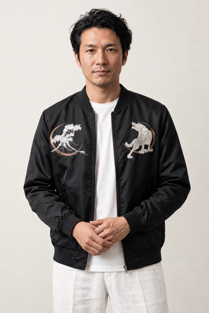 White Wolf Souvenir Jacket 'Makami' – black bomber jacket with embroidered white wolf patches, Japanese streetwear souvenir jacket, front view on model