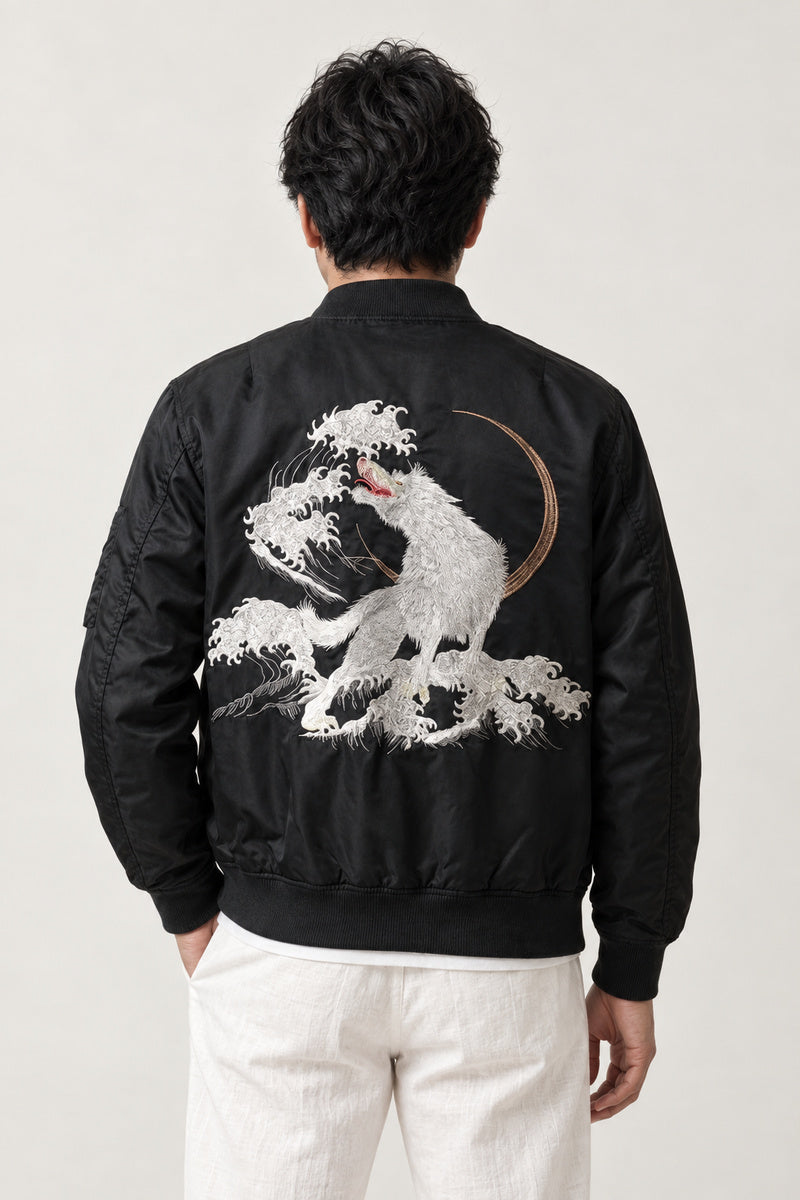 White Wolf Souvenir Jacket 'Makami' – back view of black bomber jacket showing the embroidered white wolf over waves