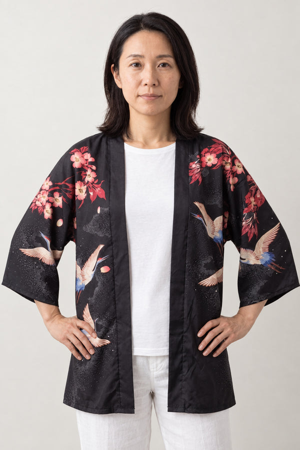 Women's Crane Whirlpool Kimono Top 'Kirisame' – black women's kimono top with cranes, whirlpool waves and cherry blossom print, Japanese haori style jacket, front view on model
