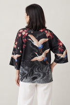 Women's Crane Whirlpool Kimono Top 'Kirisame' – back view of black kimono top showing cranes over swirling waves and sakura print