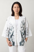 Women's Ink Crane Kimono Jacket 'Ashiwara' – white women's kimono jacket with ink-painted cranes and reeds print, Japanese haori style cardigan, front view on model