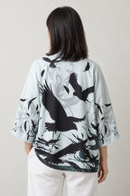 Women's Ink Crane Kimono Jacket 'Ashiwara' – back view of pale kimono jacket showing black ink cranes in flight print