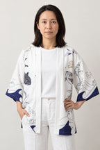 Women's Koi Kimono Jacket 'Murasaki' – white version of the koi kimono jacket with blue waves, front view on model