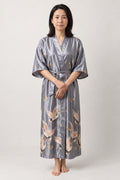 Women's Long Satin Robe 'Tsurugin' – silver grey women's long satin-look kimono robe with crane print and tie belt, Japanese dressing gown, front view on model