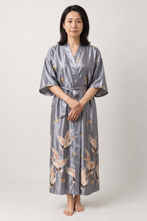 Women's Long Satin Robe 'Tsurugin' – silver grey women's long satin-look kimono robe with crane print and tie belt, Japanese dressing gown, front view on model
