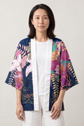 Women's Magenta Haori Kimono 'Yoiyami' – navy and magenta women's haori kimono jacket with cranes, peonies and wisteria print, Japanese kimono style cardigan, front view on model