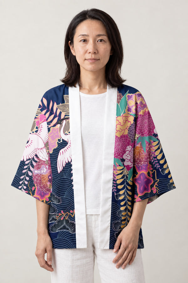 Women's Magenta Haori Kimono 'Yoiyami' – navy and magenta women's haori kimono jacket with cranes, peonies and wisteria print, Japanese kimono style cardigan, front view on model