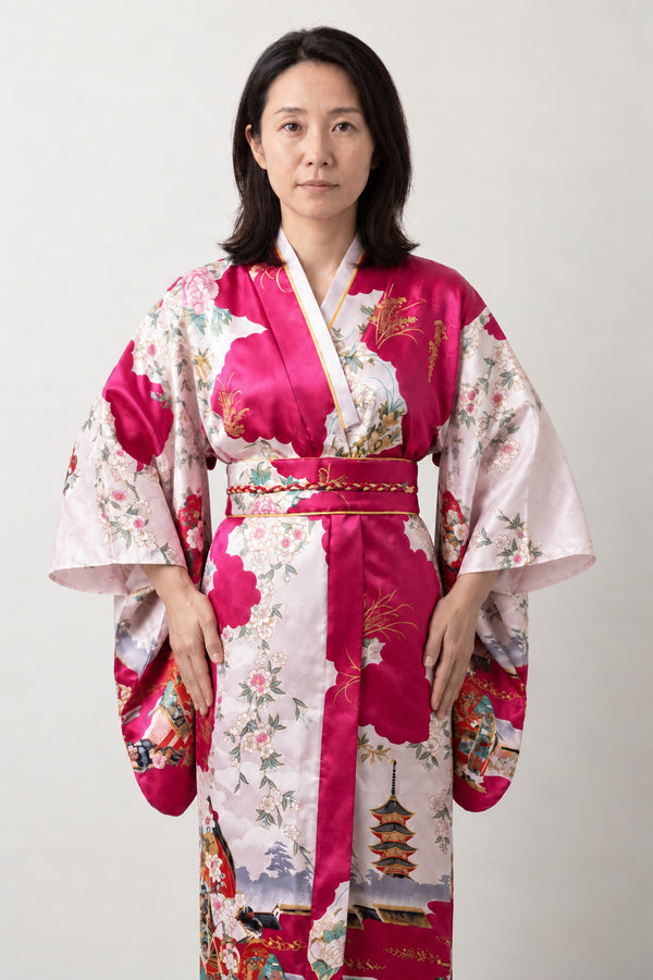 Women's Magenta Kimono Robe 'Tsutsuji' – magenta pink women's kimono robe with peacock and floral print and red obi sash, long Japanese satin-look kimono, front view on model