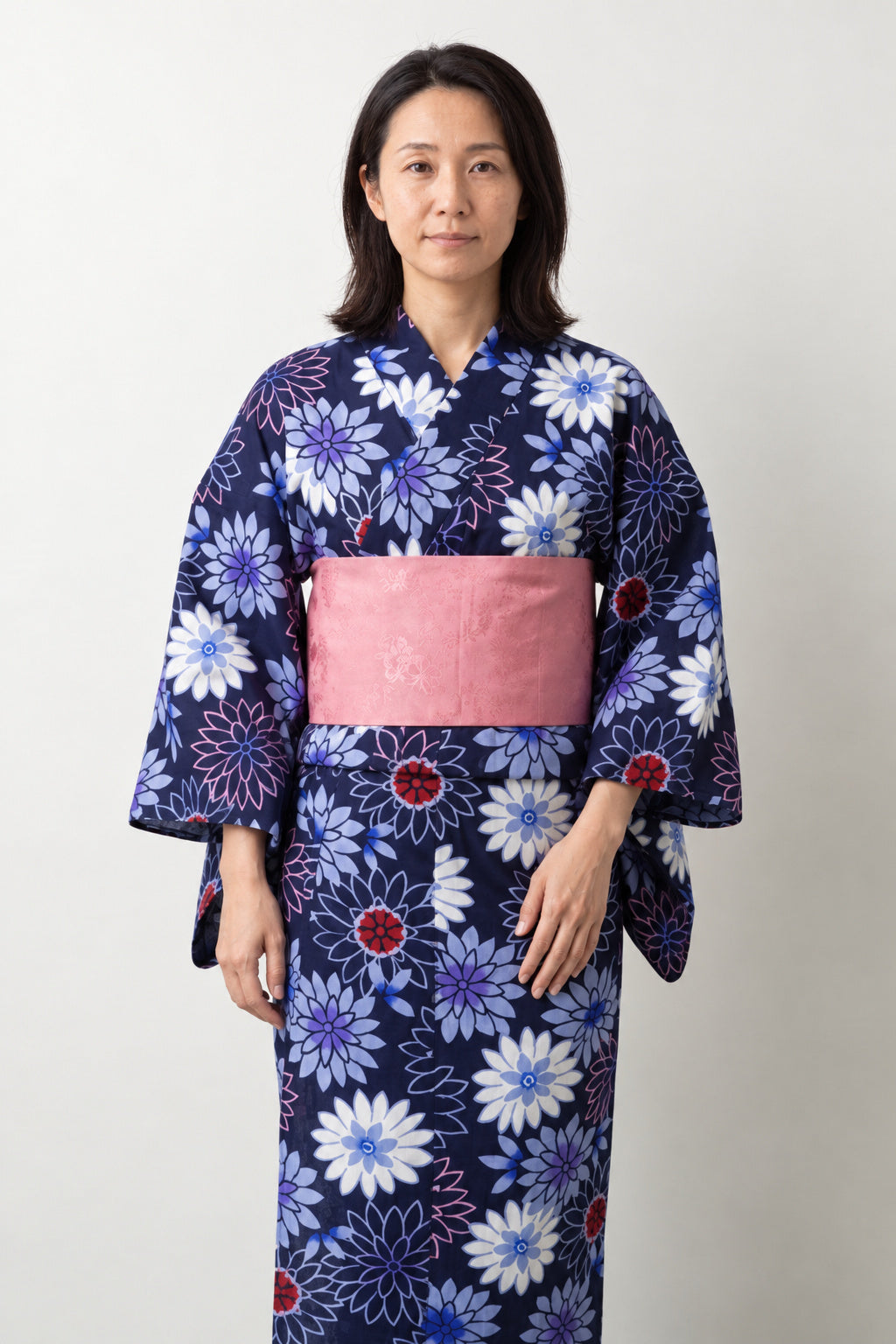 Women's Navy Chrysanthemum Yukata 'Kikka' – navy women's yukata with white and blue chrysanthemum print and pink obi belt, traditional Japanese summer kimono, front view on model