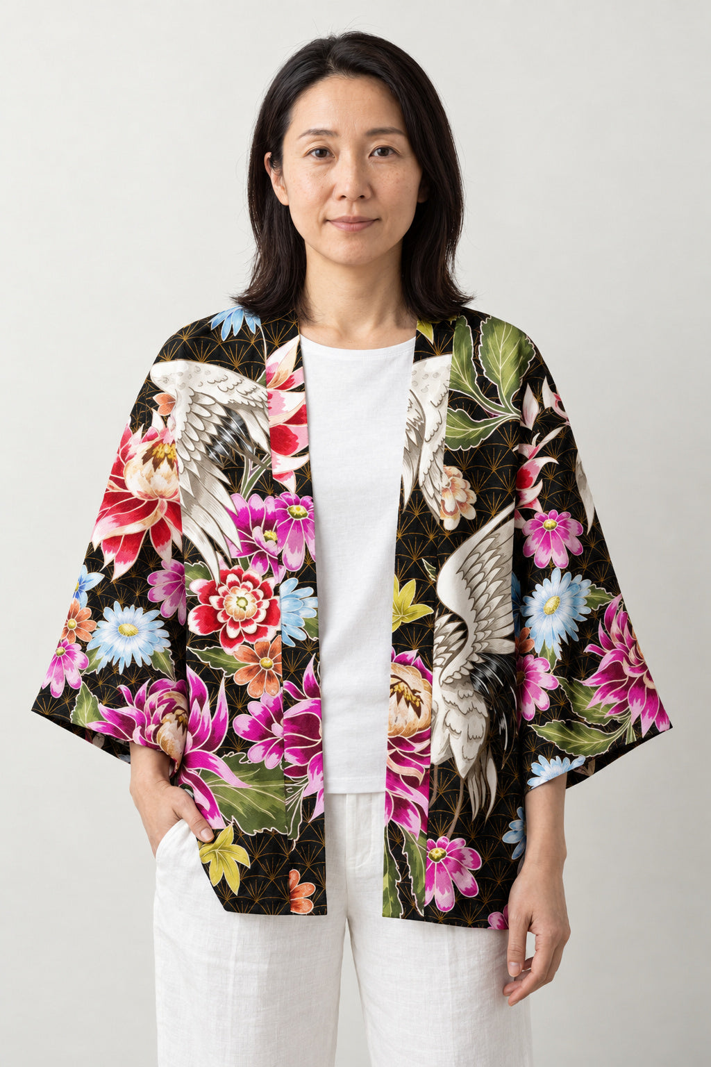 Women's Peony Haori Jacket 'Hyakka' – black women's haori jacket with pink peony, chrysanthemum and crane print, Japanese kimono style cardigan, front view on model